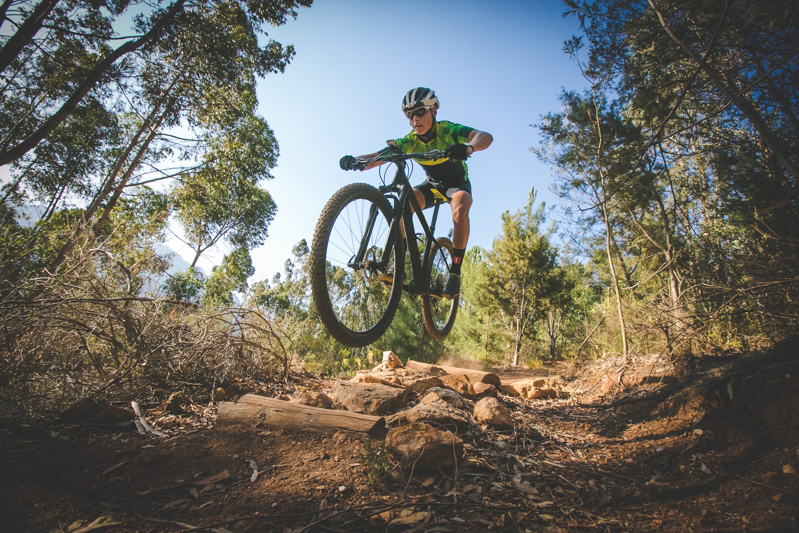 Wide angle view of a mountain biker speeding downhill on a mountain bike track in the woods Mccall Idaho