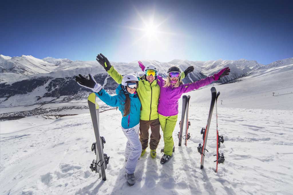 Smiling girl in blue jacket skiing Tamarack resort